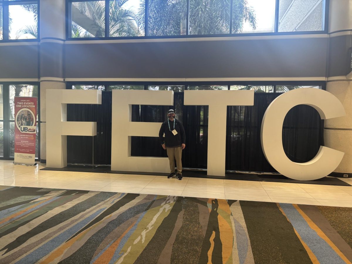 Mr. King posing in front of the entrance of  the Future of Education Technology Conference. (Photo provided by Mr. King)